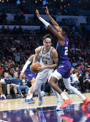 Jan 19, 2024; Charlotte, North Carolina, USA; San Antonio Spurs forward Zach Collins (23) moves past Charlotte Hornets guard forward Brandon Miller (24) during the second half at the Spectrum Center.